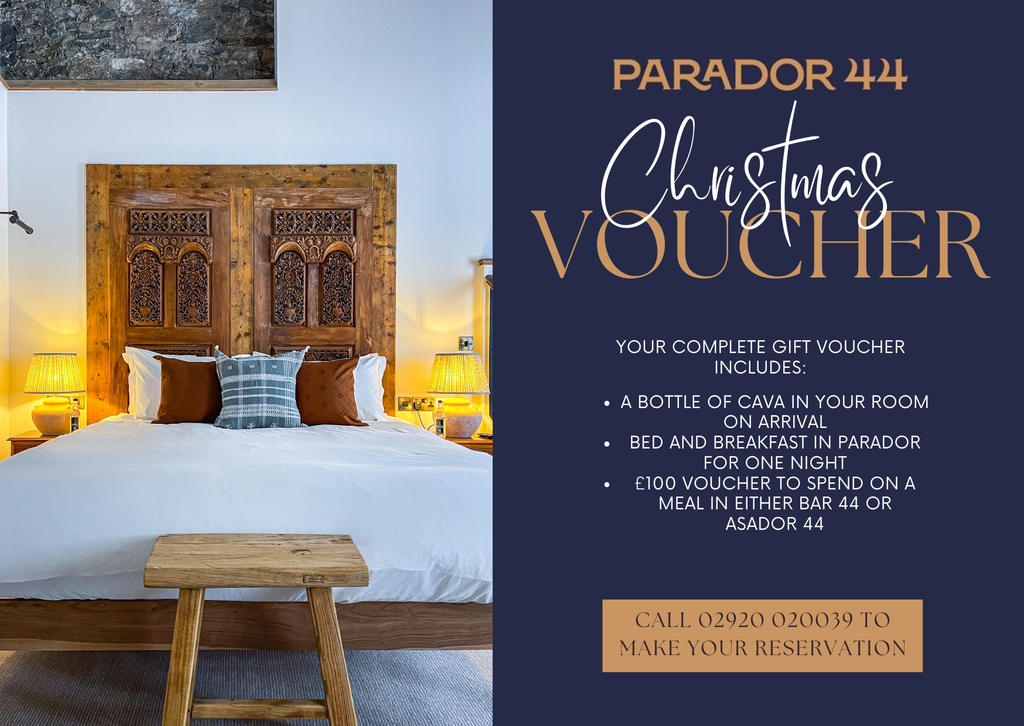 Advertisement for Parador 44 Christmas Voucher with a bedroom scene and contact information.
